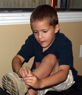 boy tying shoelaces